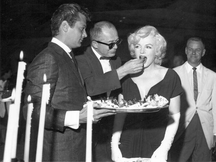 Marilyn Monroe plunging black cocktail dress worn at a Beverly Hills party