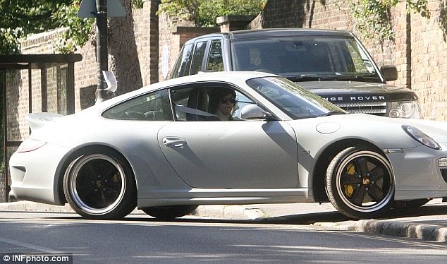 Harry Stylestes driving a classic grey Porsche 911 Sport Classic