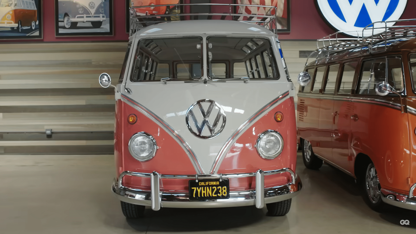 Comedian Gabriel Iglesias standing in front of a two-tone white and pink 1959 23-Window Volkswagen T1 Bus.