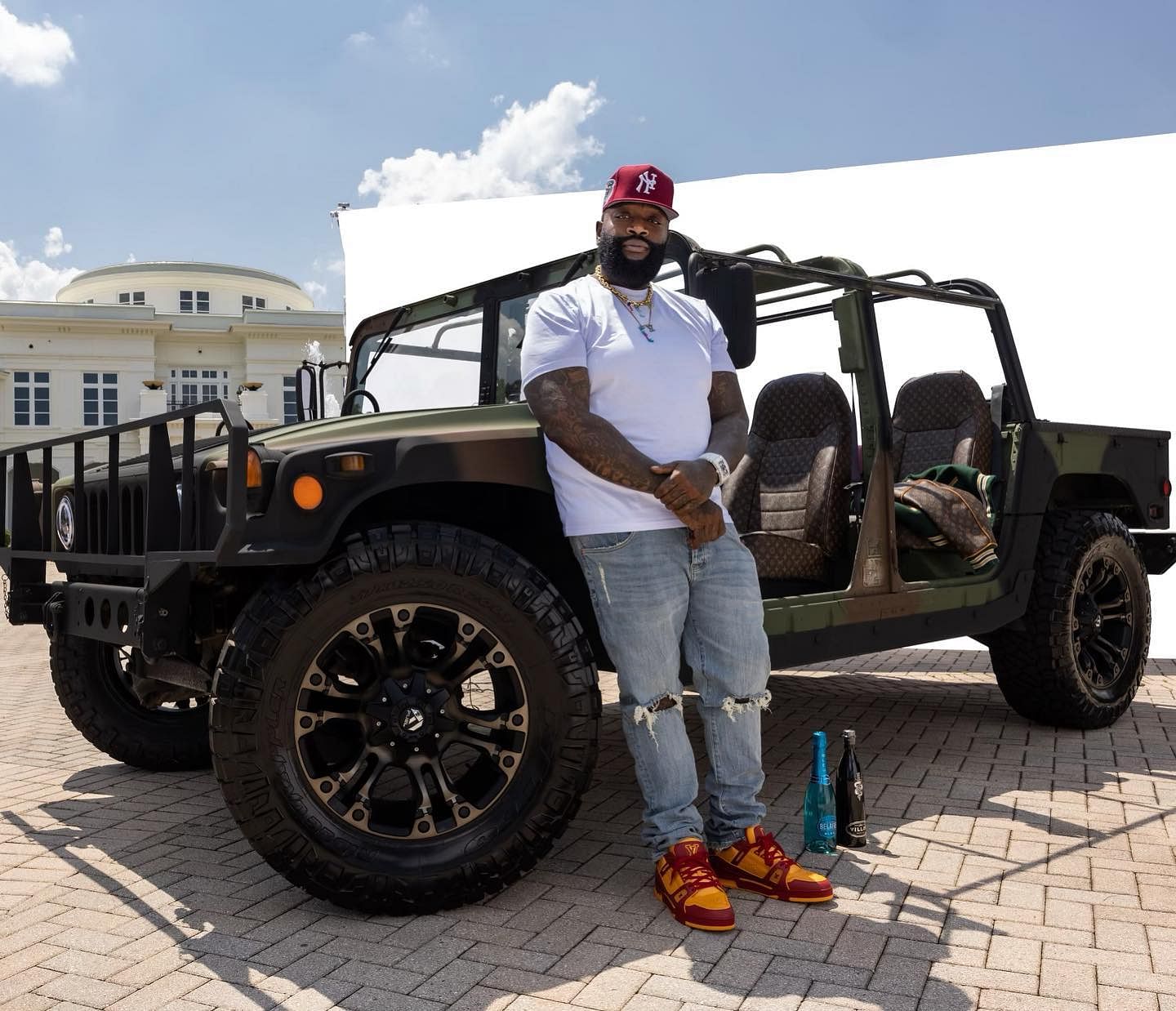 Rick Ross standing infront of his custom Maybach Louis Vitton Humvee