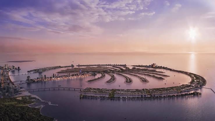 Aerial view of a luxury waterfront villa on Palm Jumeirah with the Dubai skyline in the background