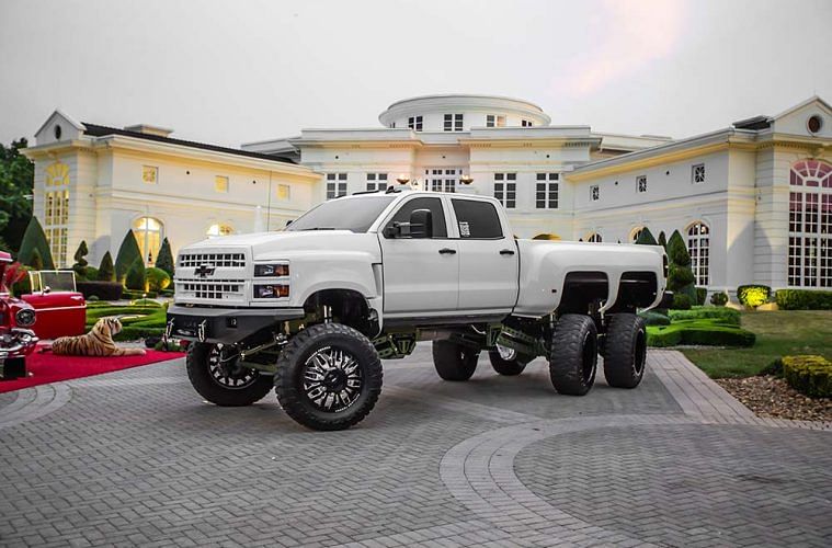 Rick Ross' Custom Chevrolet Silverado 5500 6x6 Truck parked infront of 'The Promise Land'