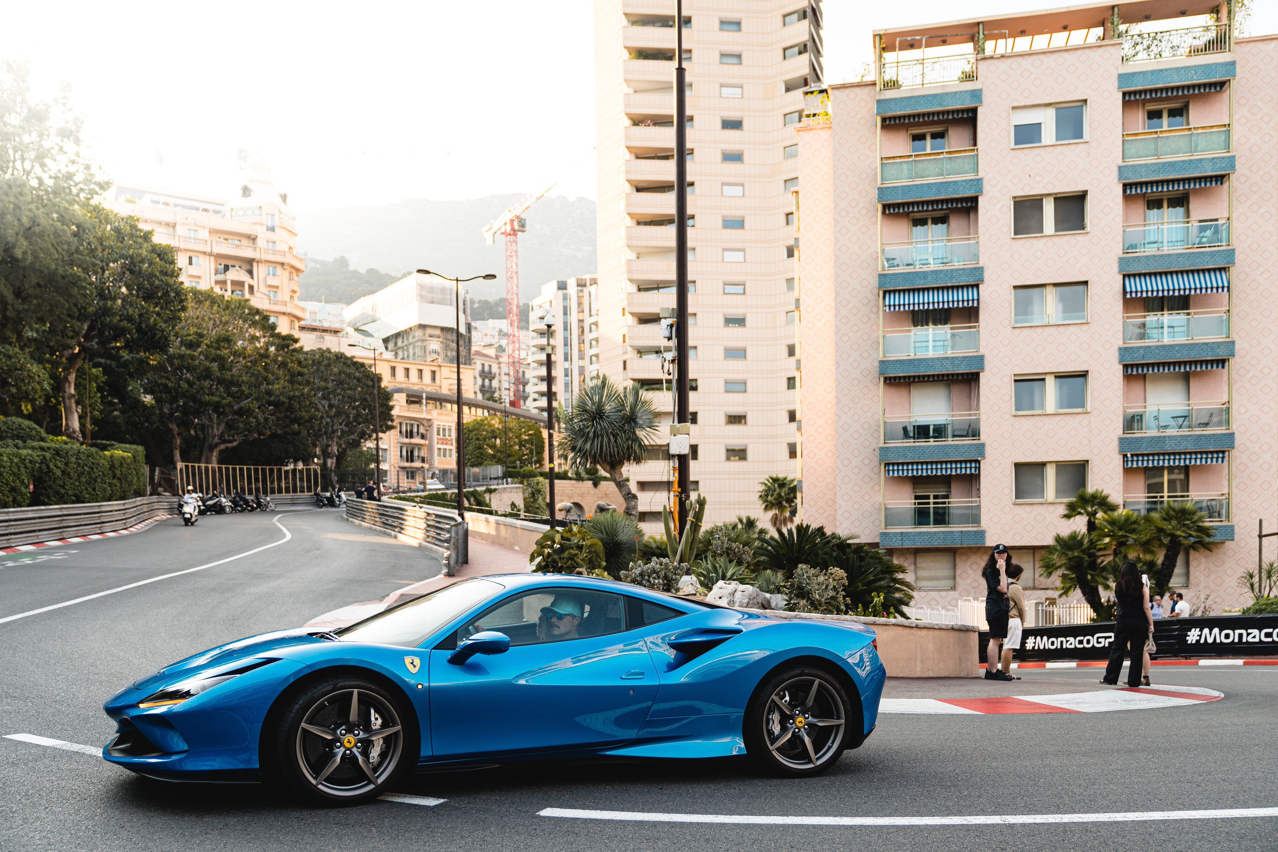 Valtteri Bottas driving around the streets of Monaco in his blue Ferrari F8 Tributo