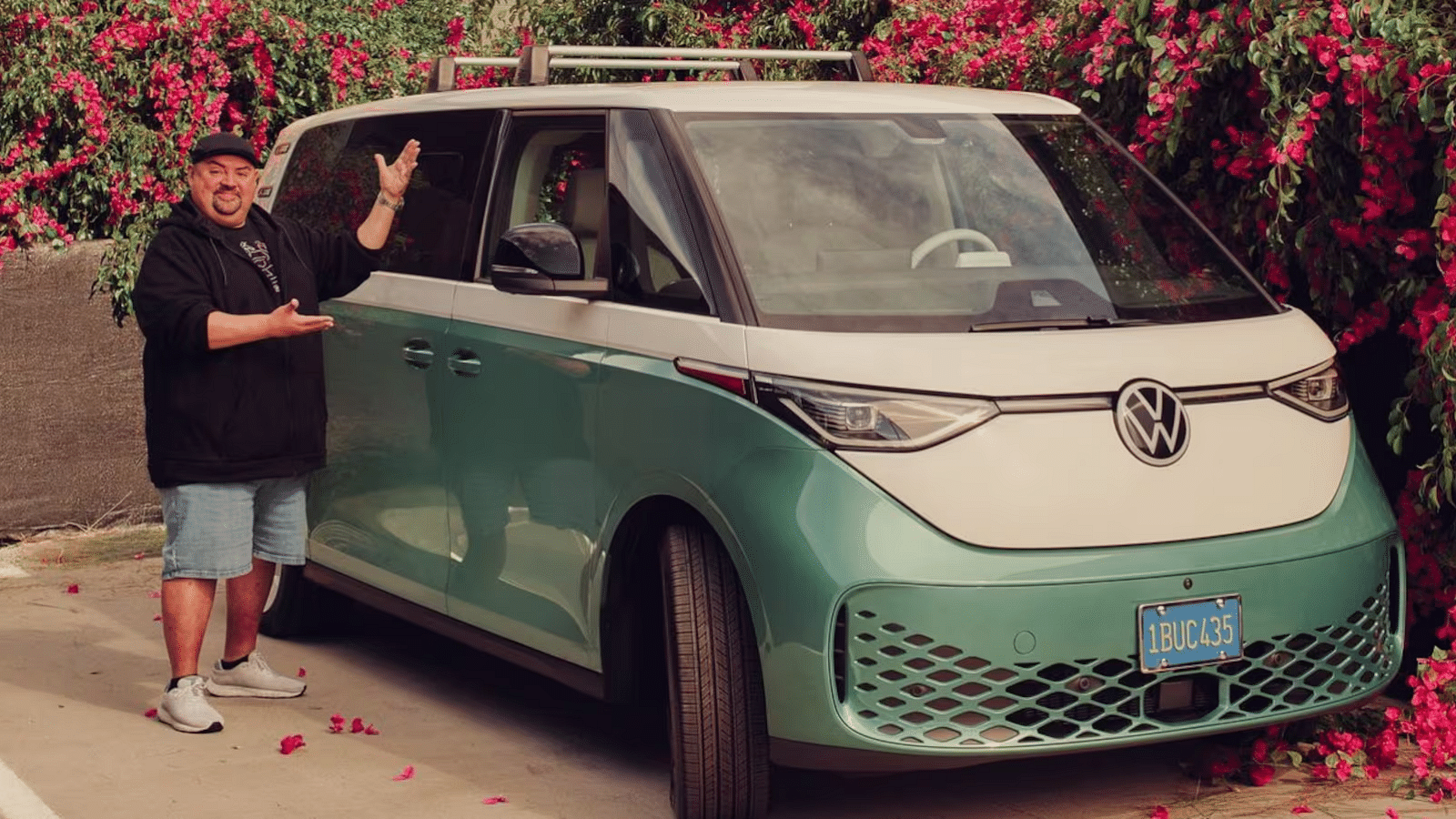 Gabriel Iglesias with his brand-new Volkswagen ID. Buzz and also the first owner of the the vehicle in North America.