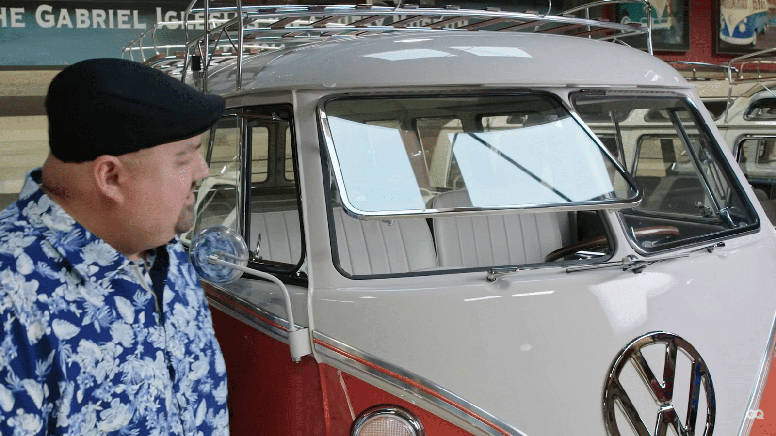 Comedian Gabriel Iglesias standing in front of a two-tone white and pink 19-Window Volkswagen Ragtop Bus.