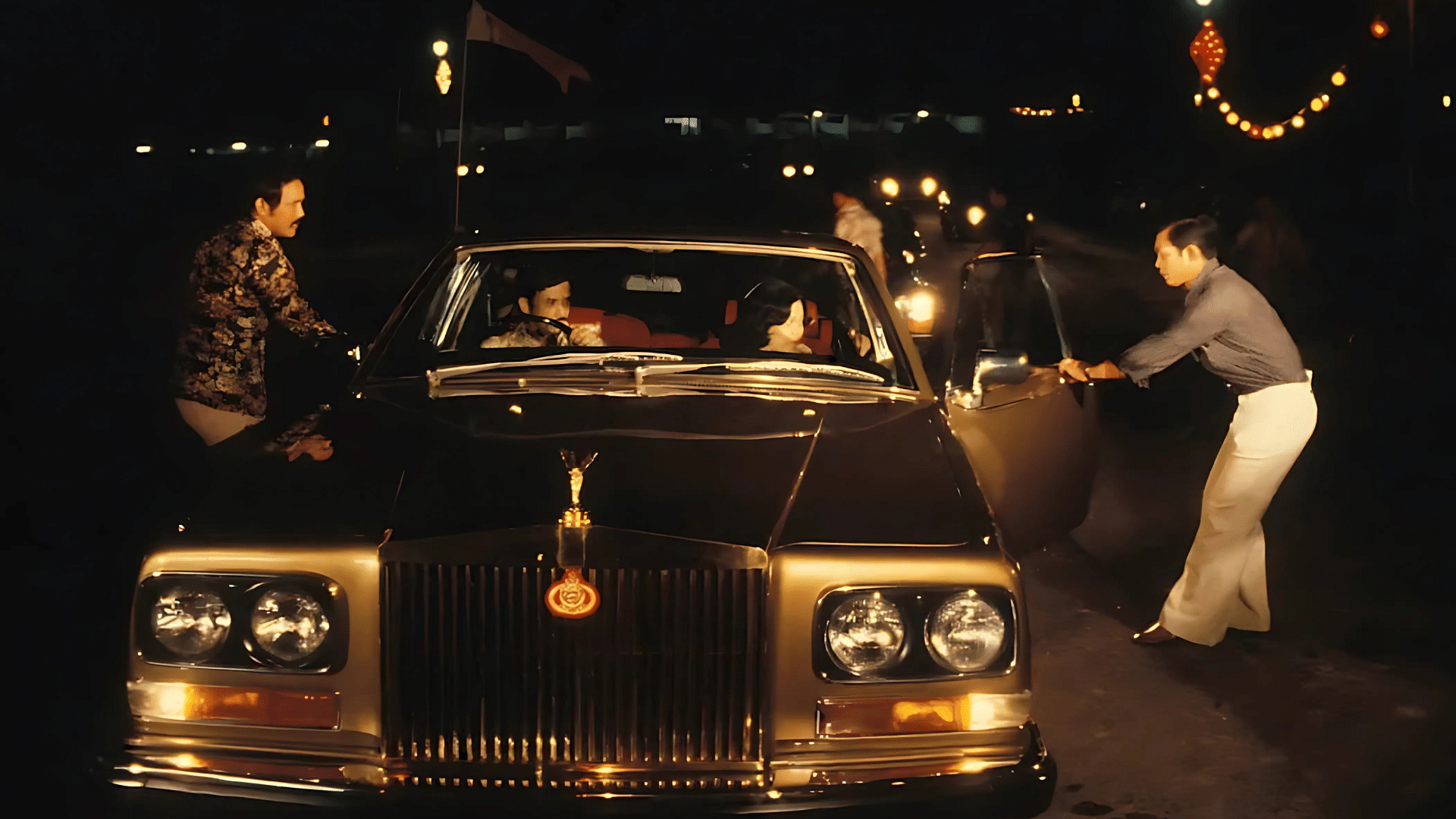 Sultan of Brunei's shown in the driver seat of the black Rolls-Royce Camargue along with his wife, queen of Brunei